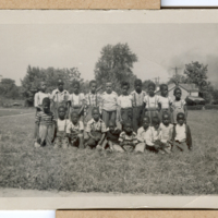 MAF0419_photograph-of-male-students-kneeling-in-the-grass.jpg